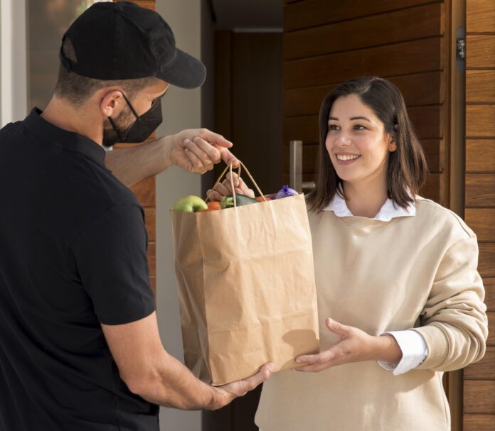 Woman Getting Food Bag Delivered